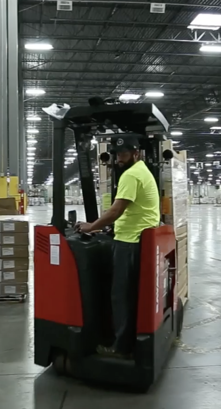 Retail Warehouse worker using fork lift